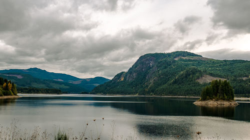 Scenic view of lake and mountains against sky