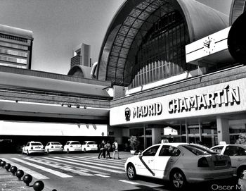 Cars on road by buildings in city