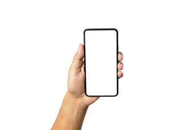 Midsection of man holding mobile phone against white background