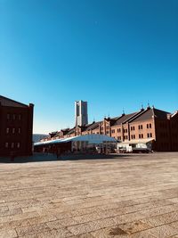 Low angle view of buildings against clear blue sky