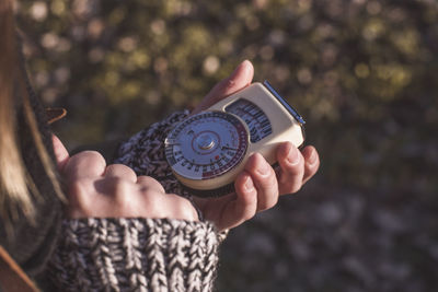 Cropped image of person holding antique navigational compass