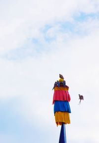 Low angle view of bird flying against sky