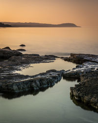 Scenic view of sea against sky at sunset