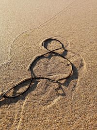 High angle view of number shape on sand