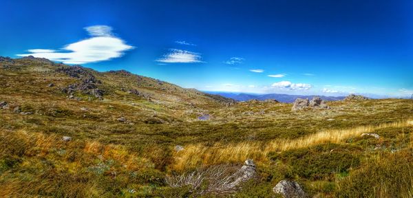 Scenic view of landscape against blue sky