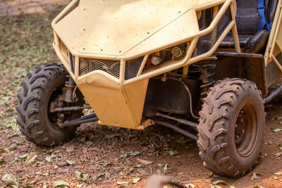 A yellow buggy is parked.