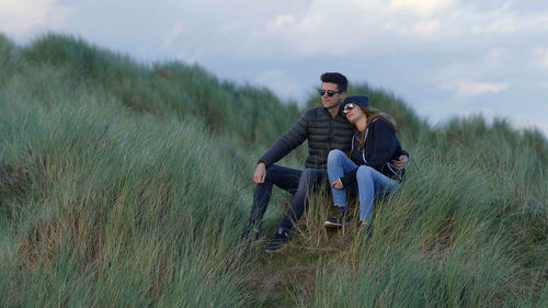 Young couple sitting on land