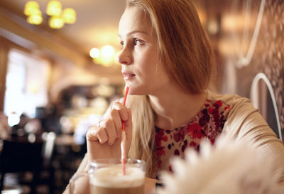 Beautiful woman having cappuccino in cafe