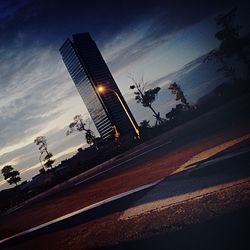 Road against cloudy sky at sunset