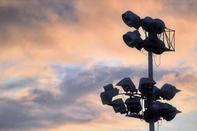 Low angle view of camera against sky during sunset