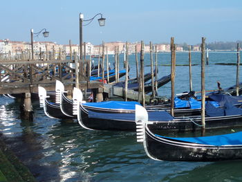 Docked gondolas with built structures in background