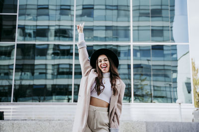 Young woman standing against built structure