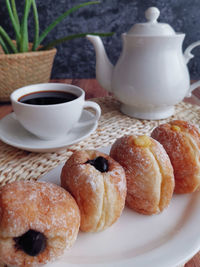 Close-up of cup and coffee on table