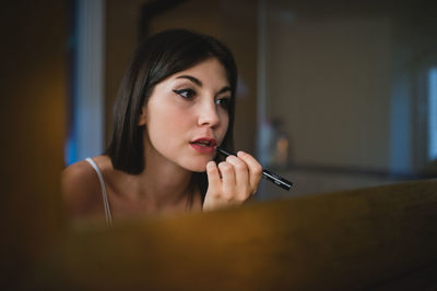 Portrait of young woman holding camera