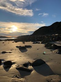 Scenic view of beach against sky during sunset