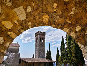 Castello di caneva against sky seen through arch