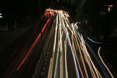 Light trails on road in city at night