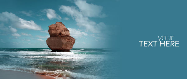 Rock formation on beach against sky