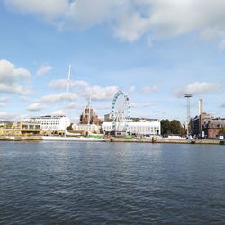 View of river by buildings against sky