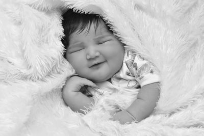 High angle view of baby sleeping on bed