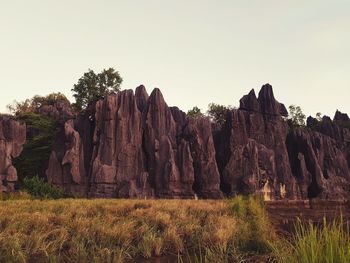 Rock formations on landscape against clear sky