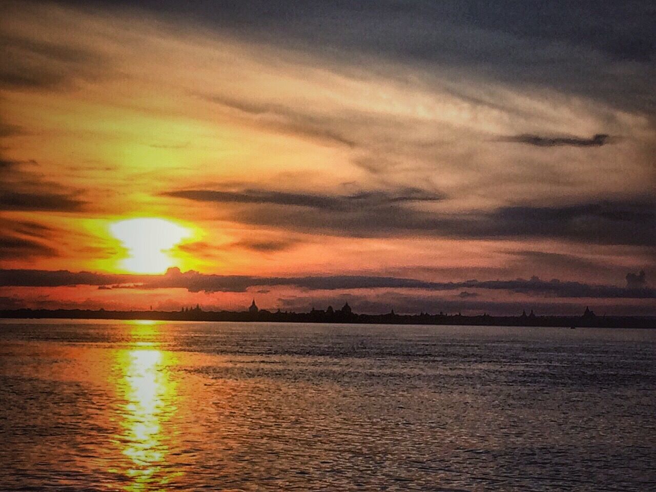 sunset, water, waterfront, scenics, tranquil scene, sky, tranquility, beauty in nature, cloud - sky, orange color, sun, idyllic, nature, rippled, cloudy, cloud, outdoors, no people, remote, non-urban scene, weather, sunbeam