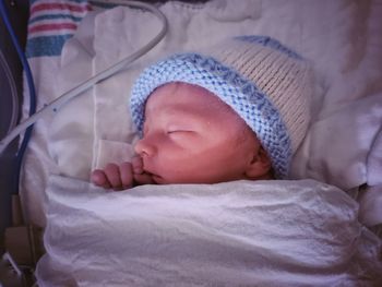 Newborn baby boy in hospital bed