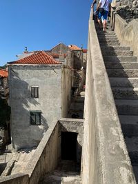 Staircase of old building in city against clear sky