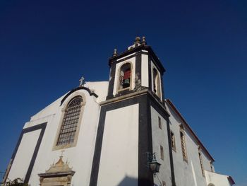 Low angle view of building against clear blue sky