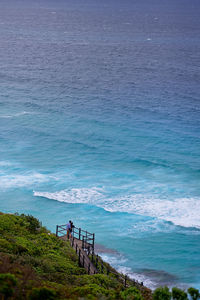 High angle view of couple contemplating the sea