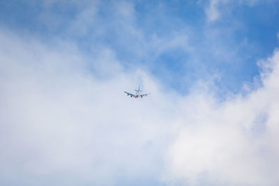 Low angle view of airplane flying in sky