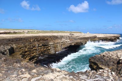 Scenic view of rocks in sea against sky