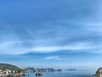 Scenic view of sea by buildings against sky