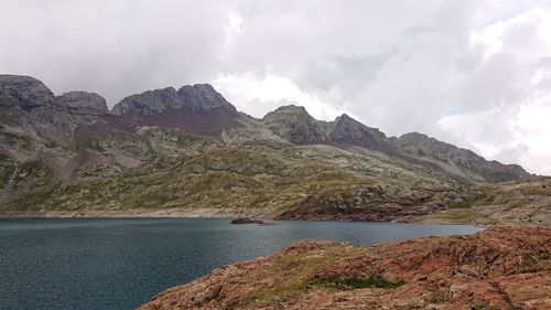 Scenic view of sea and mountains against sky