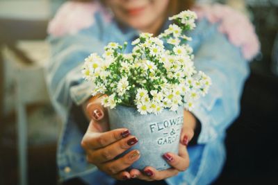 Midsection of man holding flower bouquet