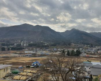 High angle view of townscape and mountains against sky