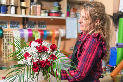 Side view of woman holding flower bouquet