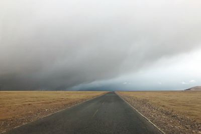 Road amidst landscape against sky during rainy season