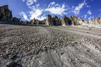 Panoramic view of rocks on land against sky