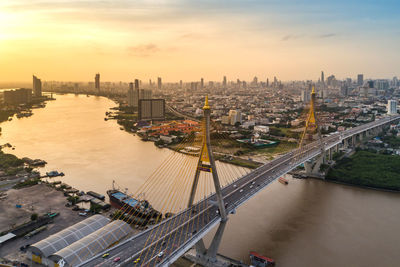 High angle view of river and buildings against sky