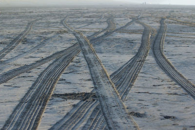 High angle view of tire tracks at beach