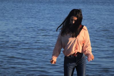 Full length of woman standing in sea