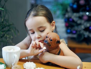 Little girl drinks hot chocolate with marshmallows during the winter holidays, christmas 