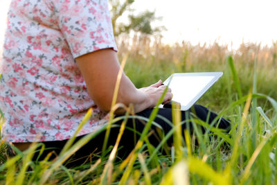 Midsection of woman reading book