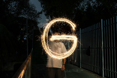 Blurred motion of man standing at night