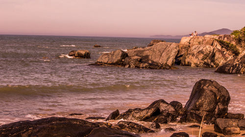 Scenic view of sea against clear sky at sunset