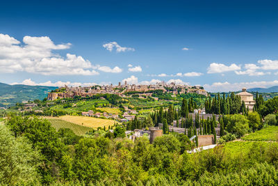 Panoramic view of trees and buildings against sky