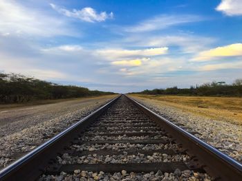 Surface level of railroad tracks against sky