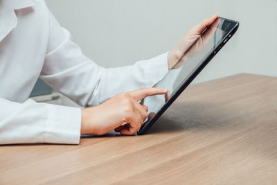 Midsection of man using mobile phone