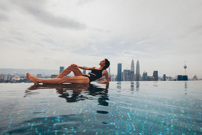 Woman relaxing at infinity pool